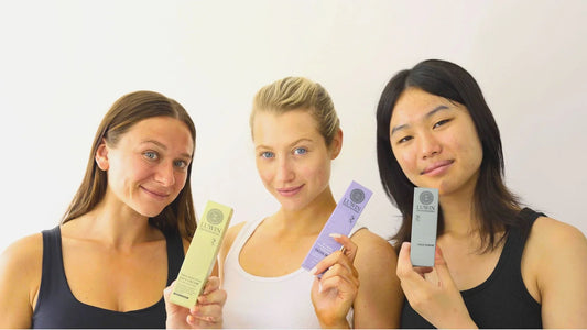female models holding up LUWIN skincare products with confident smile