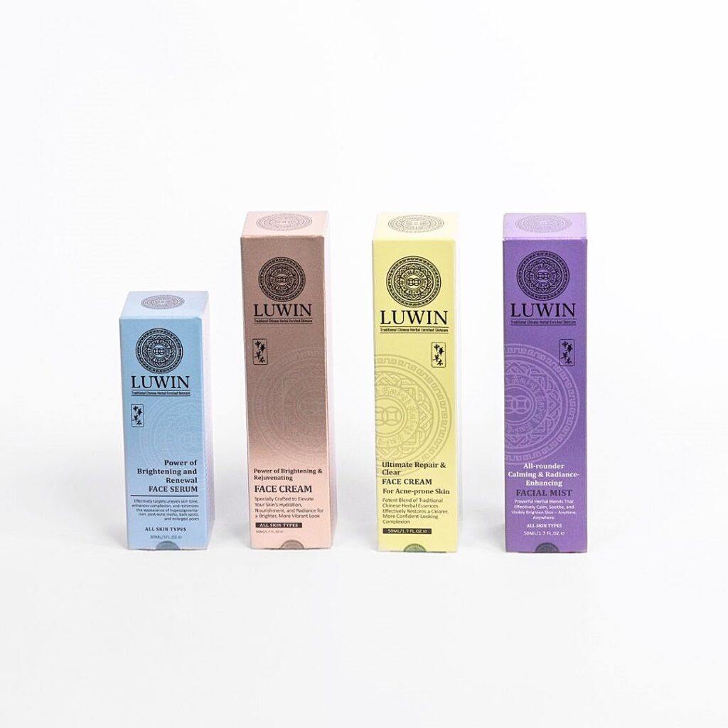 A lineup of LUWIN Power of Brightening & Renewal Face Serum, Power of Brightening & Rejuvenating Face Cream, All-rounder Calming Facial Mist, and Ultimate Repair & Clear Face Cream, each in their unique elegant colourful box packaging.
