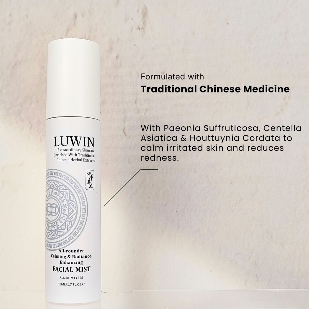 A white LUWIN all purpose facial mist bottle standing upright against a light textured background. The label highlights that the formula is enriched with Traditional Chinese Medicine herbal extracts. Text beside the product mentions Paeonia Suffruticosa, Centella Asiatica, and Houttuynia Cordata for calming irritated skin and reducing redness.