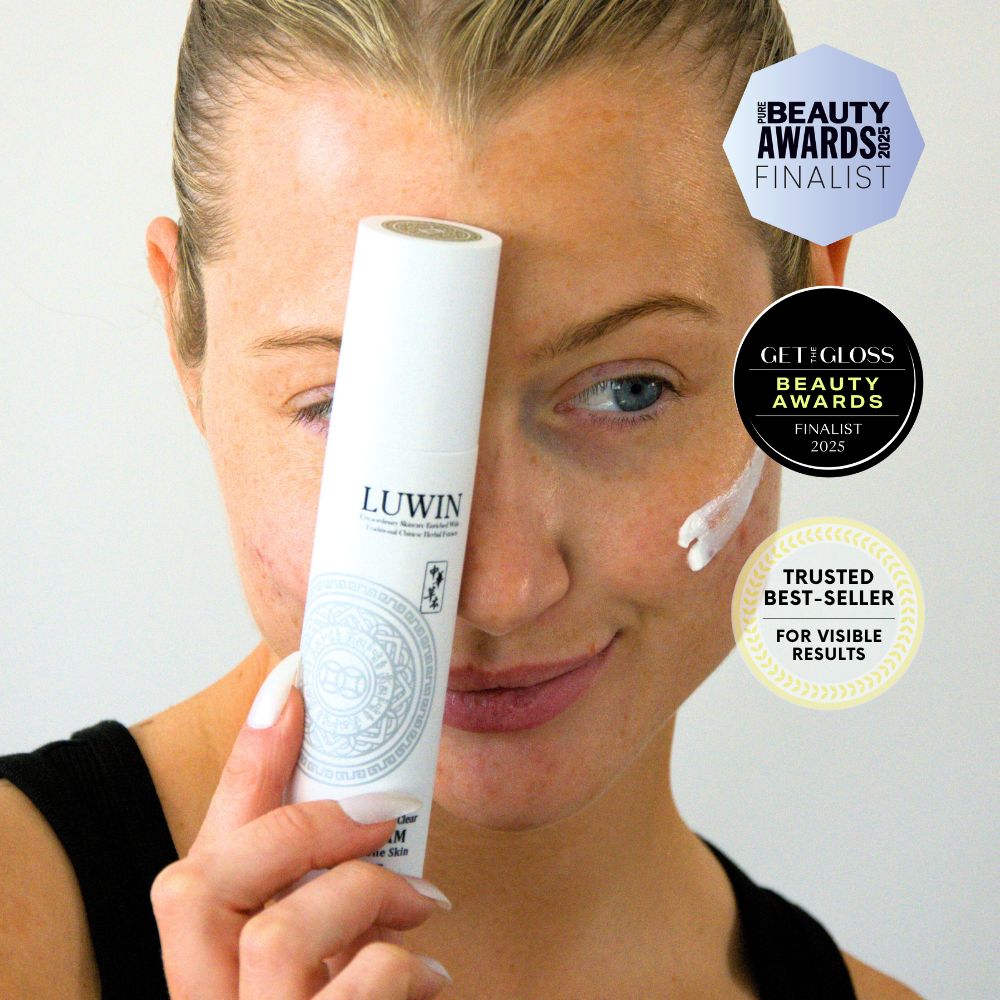 Smiling woman holding LUWIN Ultimate Repair & Clear Face Cream, award-winning skincare, with Pure Beauty Awards 2025 and Get The Gloss 2025 badges.